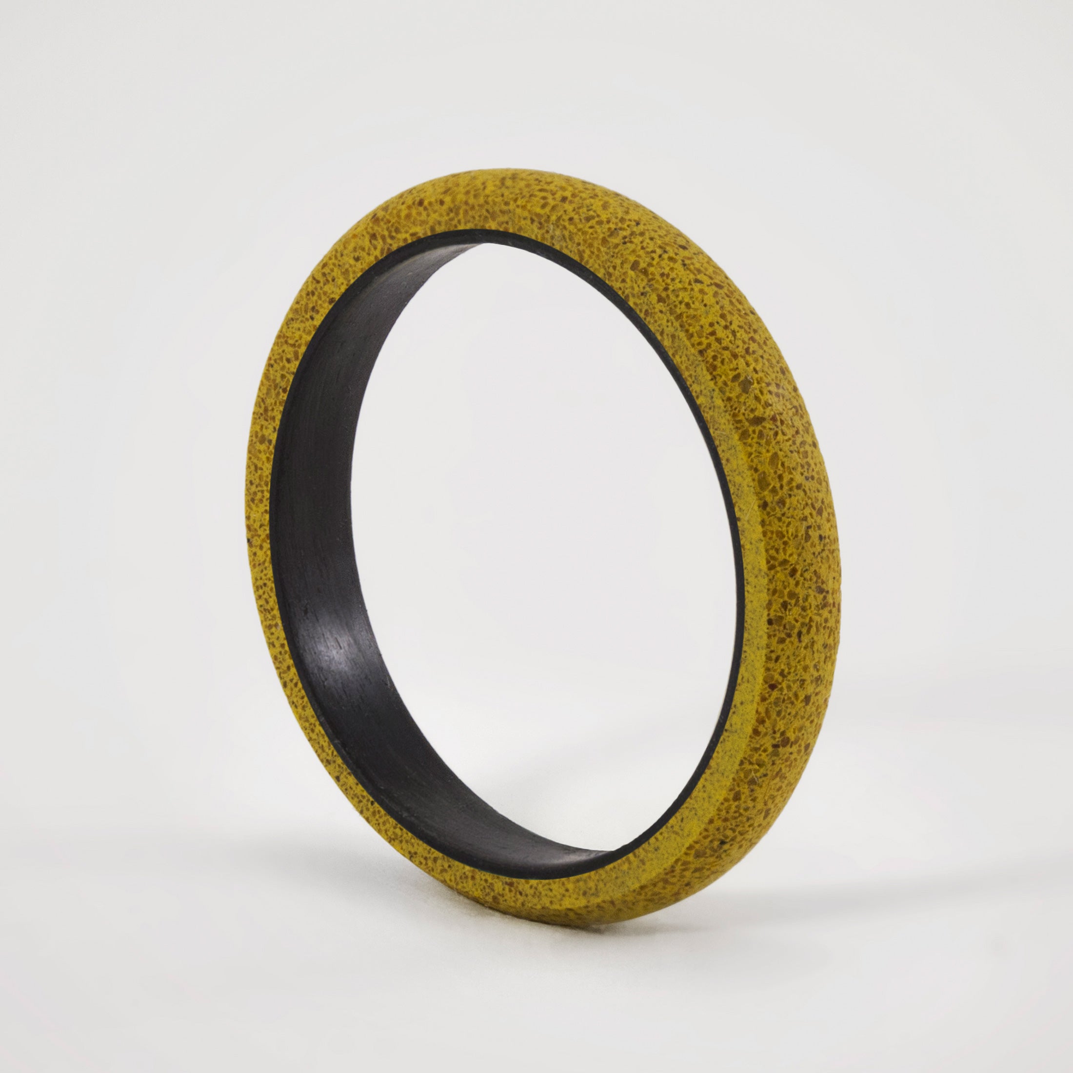 yellow concrete and carbon fiber ring