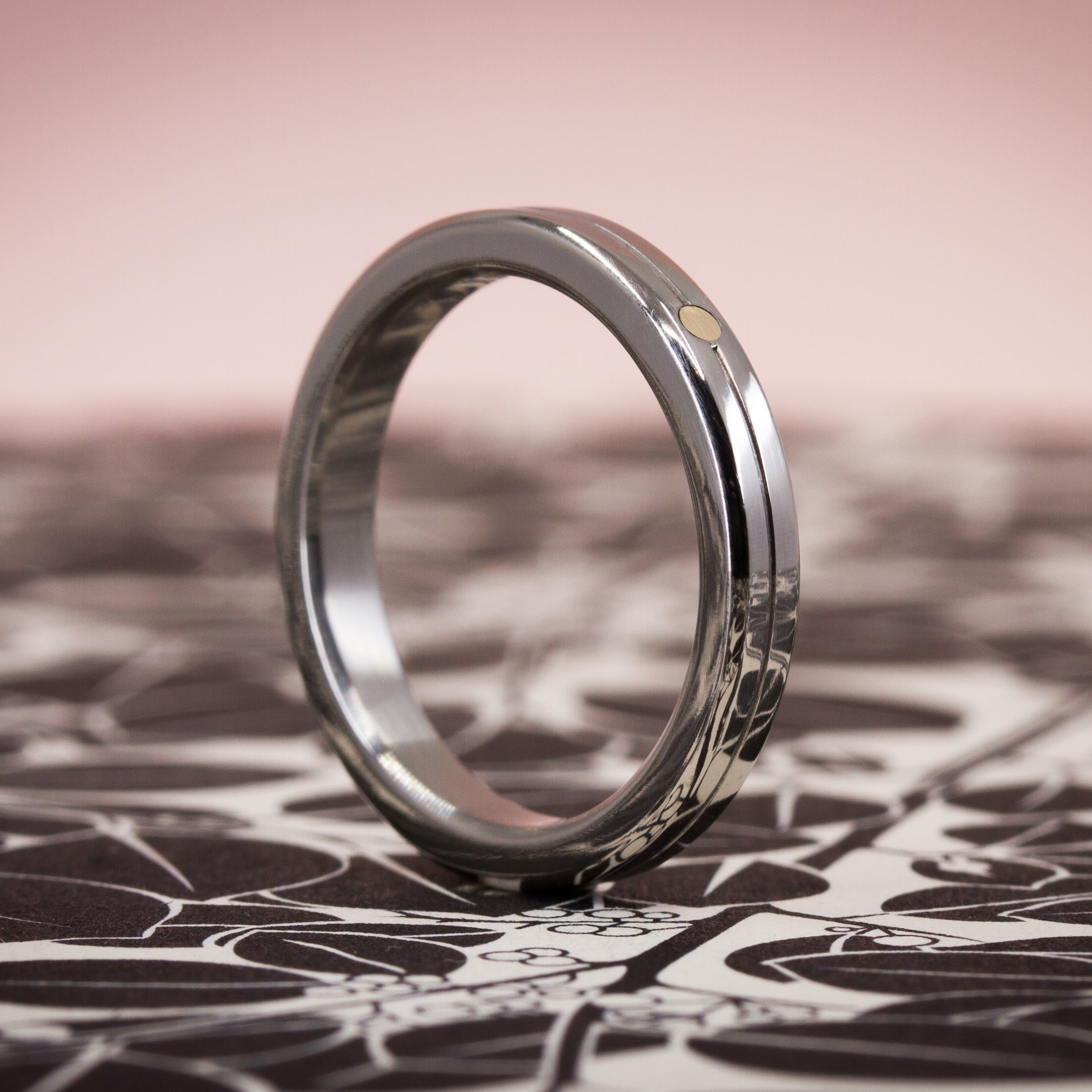 Polished titanium and golden dot ring