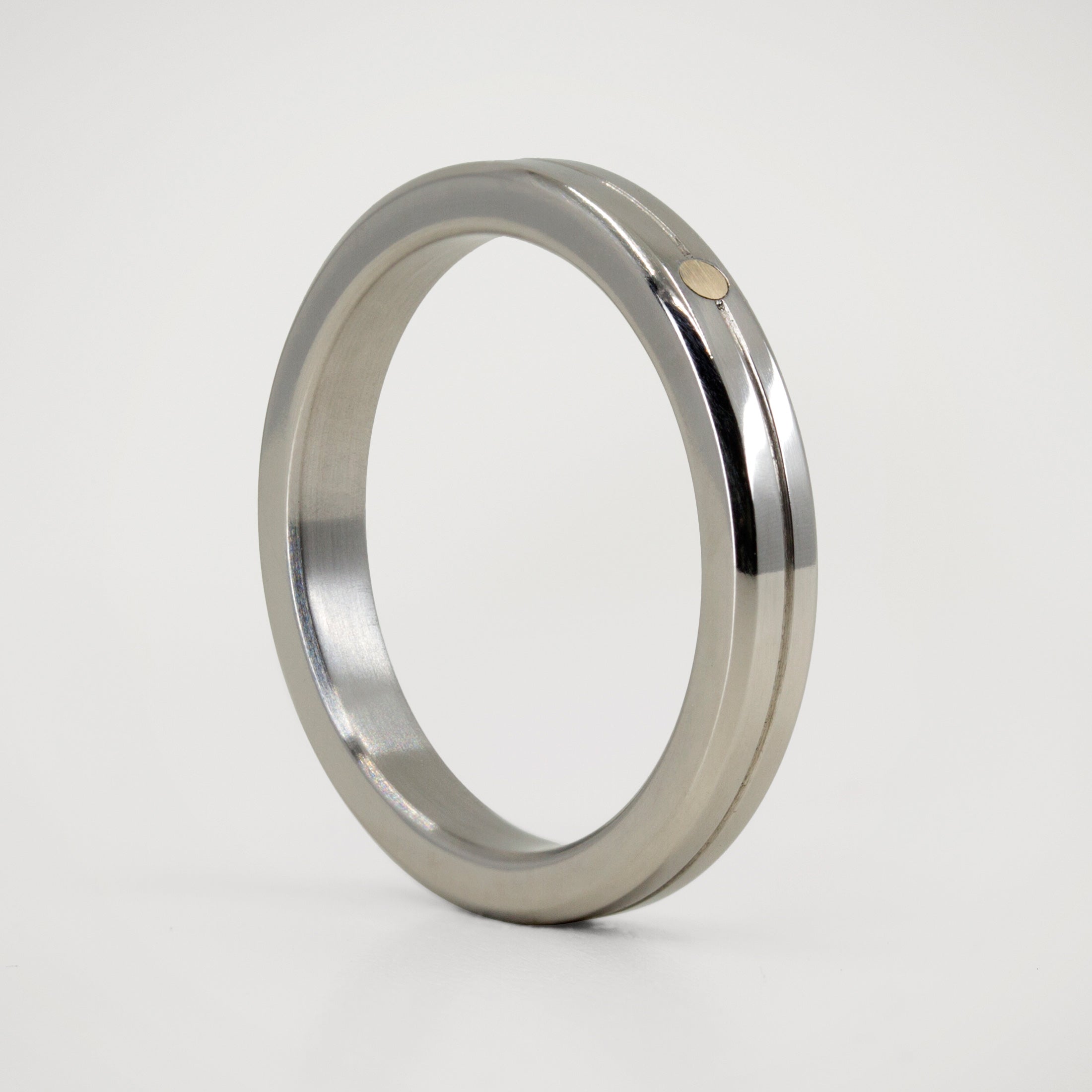Polished titanium and golden dot ring