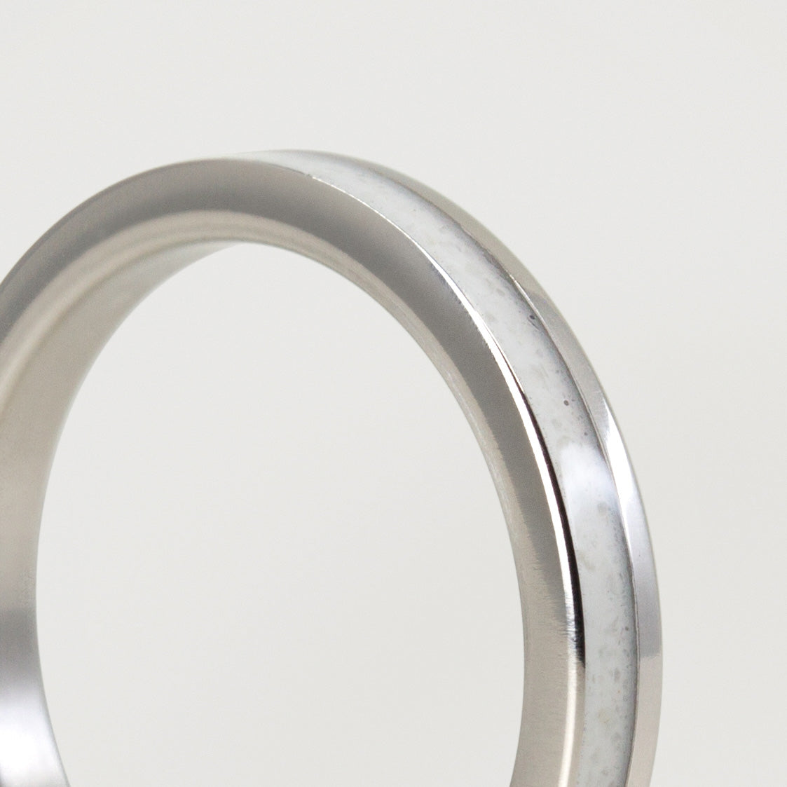 Carrara marble and offset polished titanium Ring