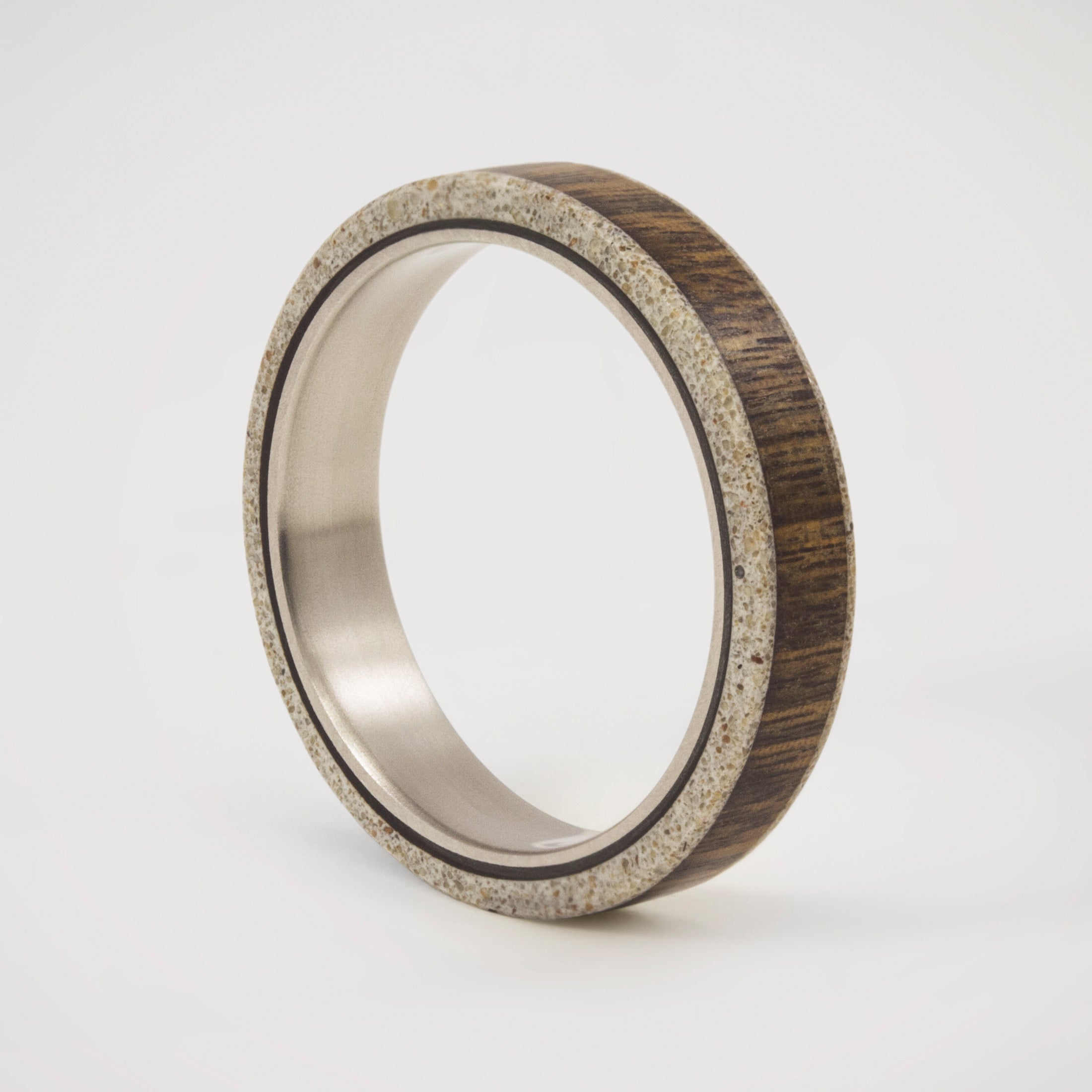 wood, gray concrete and titanium women ring