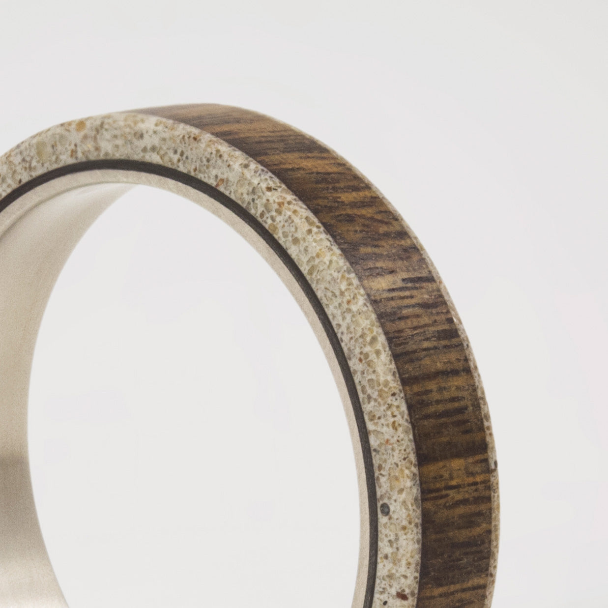 wood, gray concrete and titanium women ring