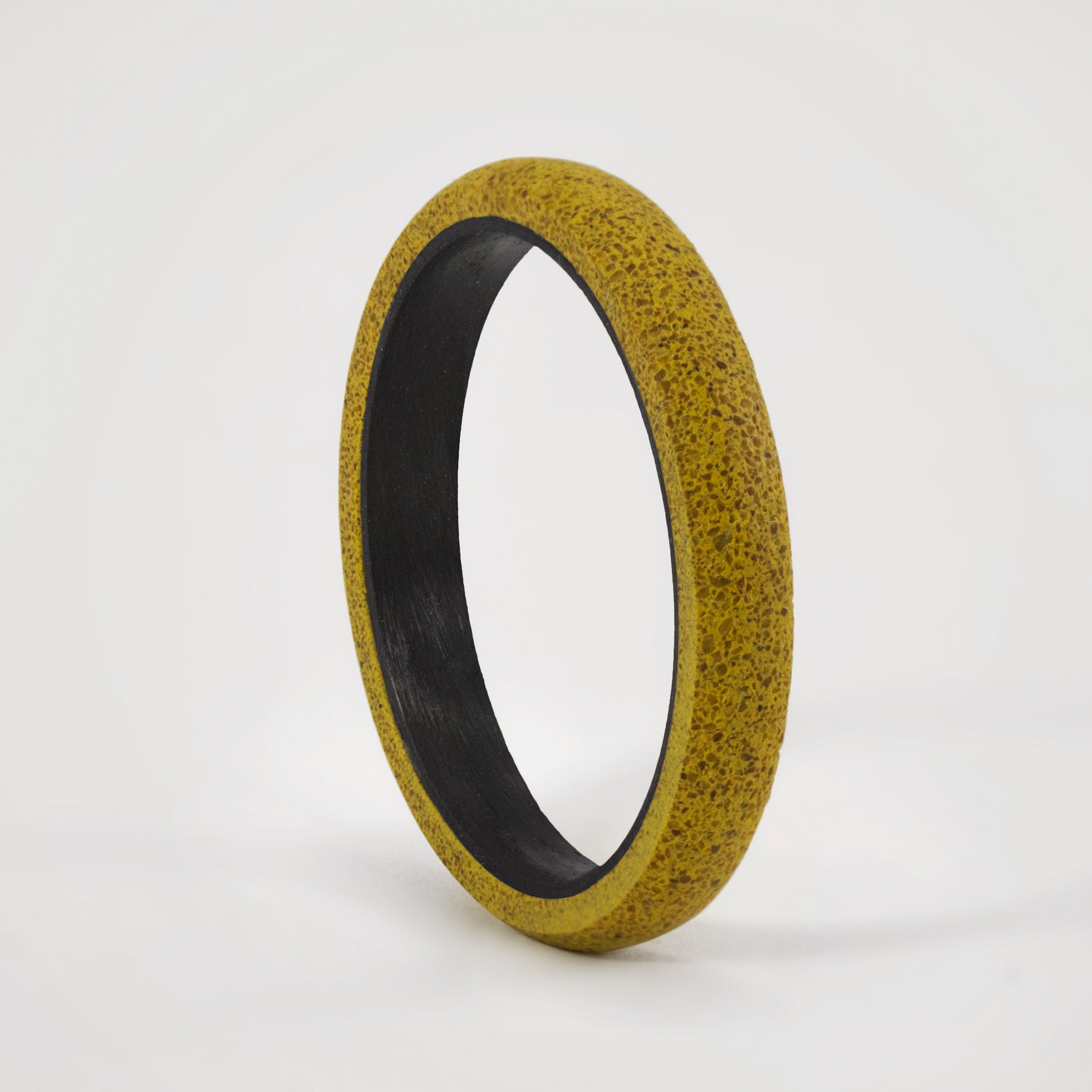 yellow concrete and carbon fiber ring