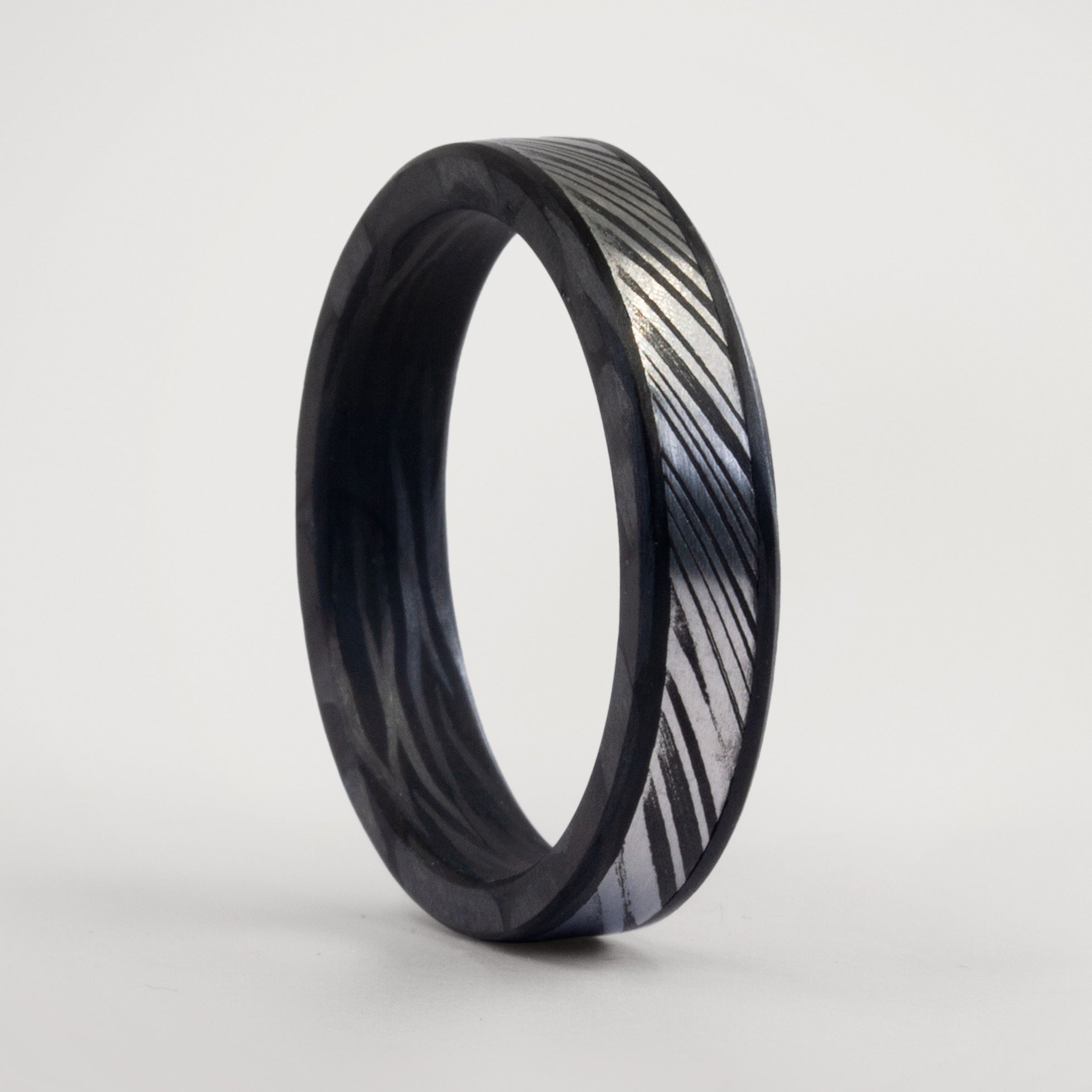 Darkened Damascus steel & wavy carbon fiber men ring