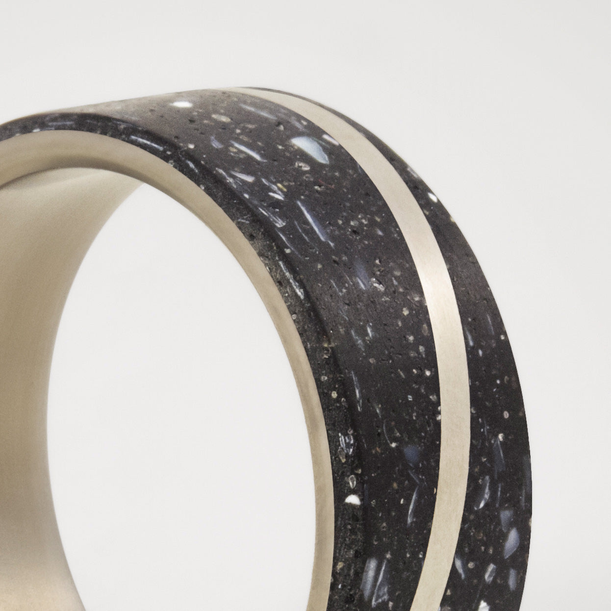 Black concrete with nacre sparkles and titanium Ring